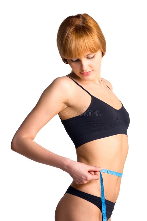 Young beautiful woman measuring her waist with a tape, isolated on white background. Lovely european female stock images, royalty-free photos and pictures