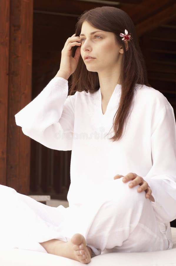 Woman Meditating In Lotus Position