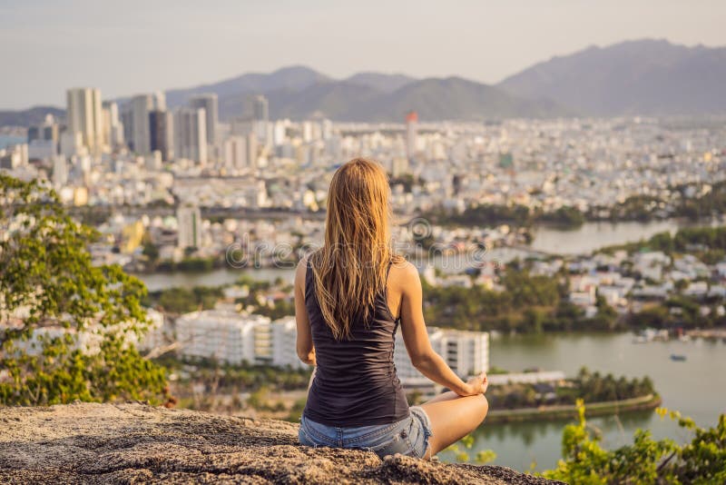 Woman Meditating and Making Yoga Outdoor Over City Background Stock ...