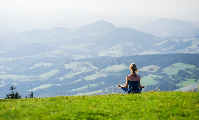 Woman meditating outdoors