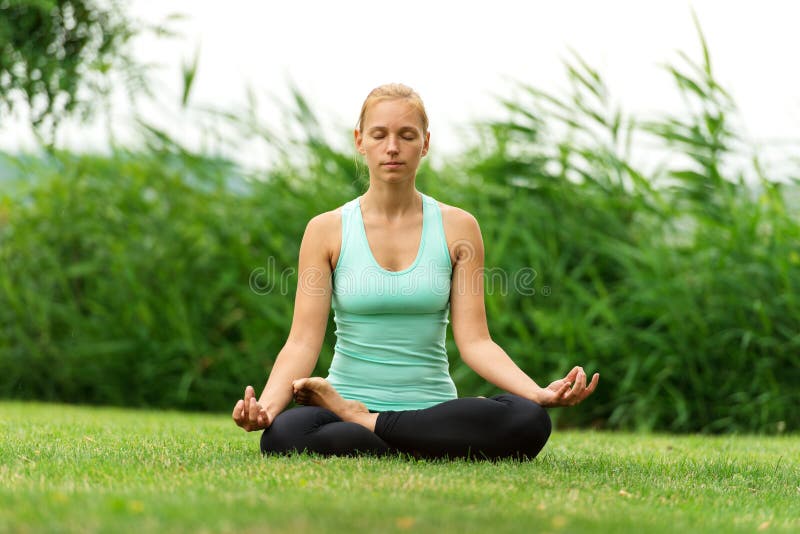 Woman meditating in pose of lotus