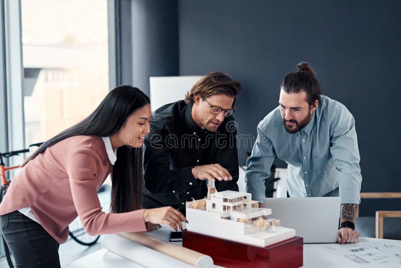 Woman, men and planning in creative workspace for design, collaboration and blueprint for engineering. Architecture royalty free stock image