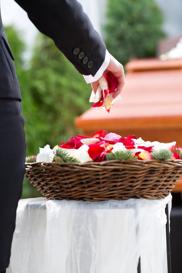 Woman mourning on Funeral with coffin. Mourning woman on funeral with flowers standing at casket or coffin royalty free stock image Woman mourning on Funeral with coffin. Mourning woman on funeral with flowers standing at casket or coffin royalty free stock image