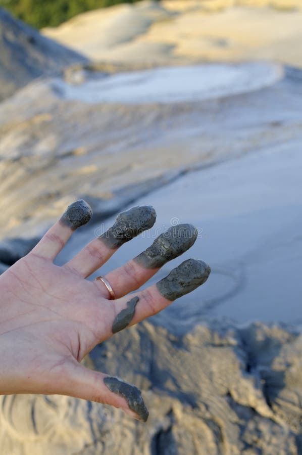 Woman with mud on fingers