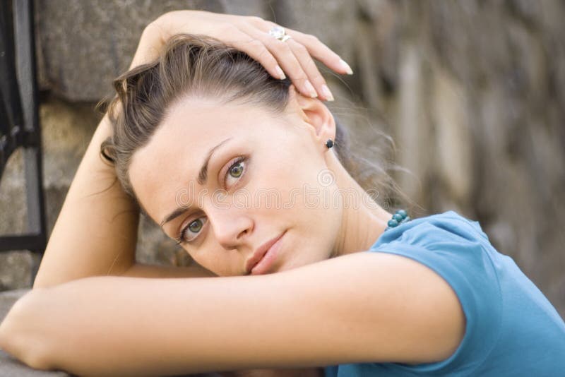 Woman near stone wall
