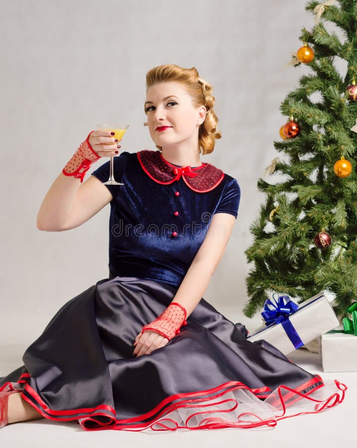 Woman next to Christmas tree