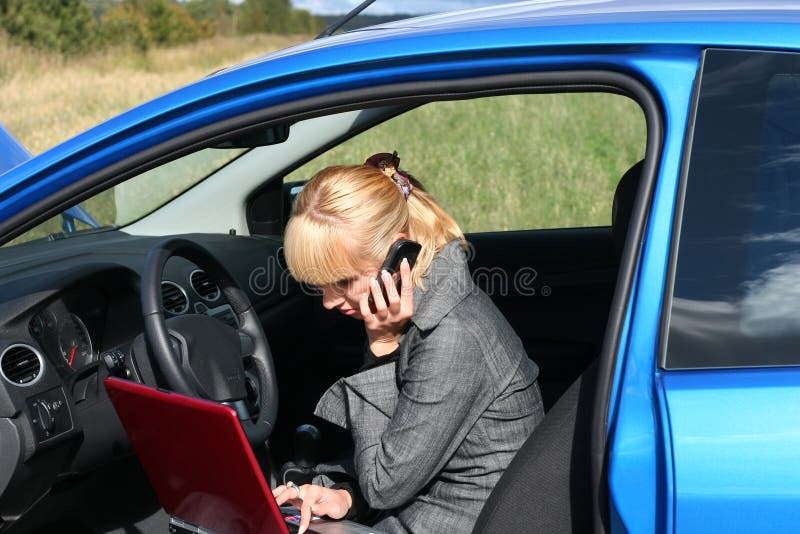 Woman with notebook in car