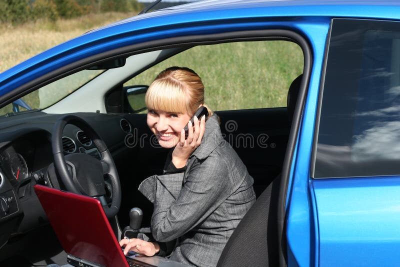 Woman with notebook in car