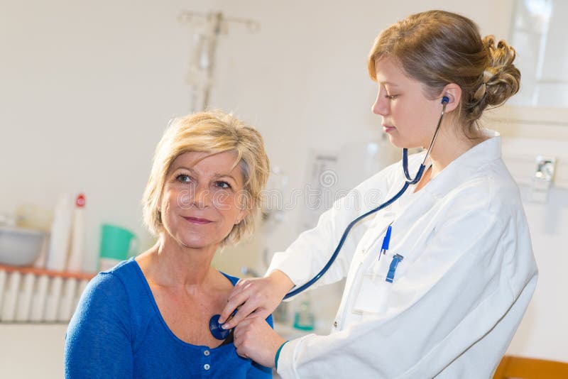 Nurse is Counting Heart Rate. Doctor Using a Stethoscope To Listen To
