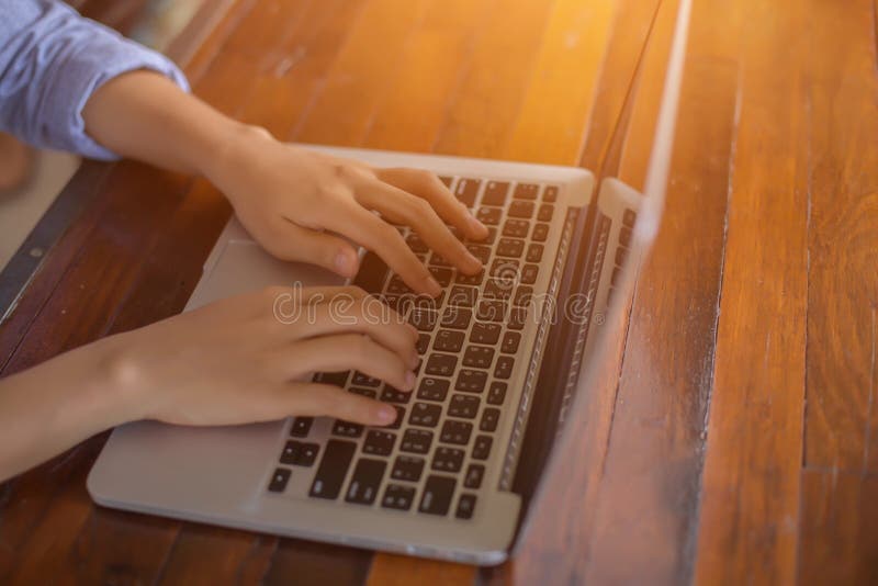 Woman office worker is typing keyboard of laptop with sunlight, business or learning concept royalty free stock photo Woman office worker is typing keyboard of laptop with sunlight, business or learning concept royalty free stock photo