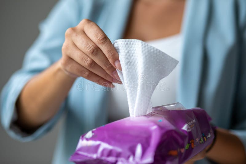 Woman open package of wet wipes to cleaning hands stock photos