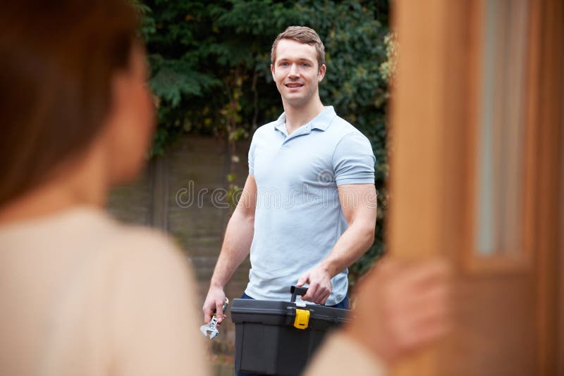 Woman Opening Door To Repairman
