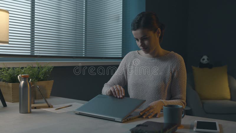 Woman opening her laptop on the desk royalty free stock photos