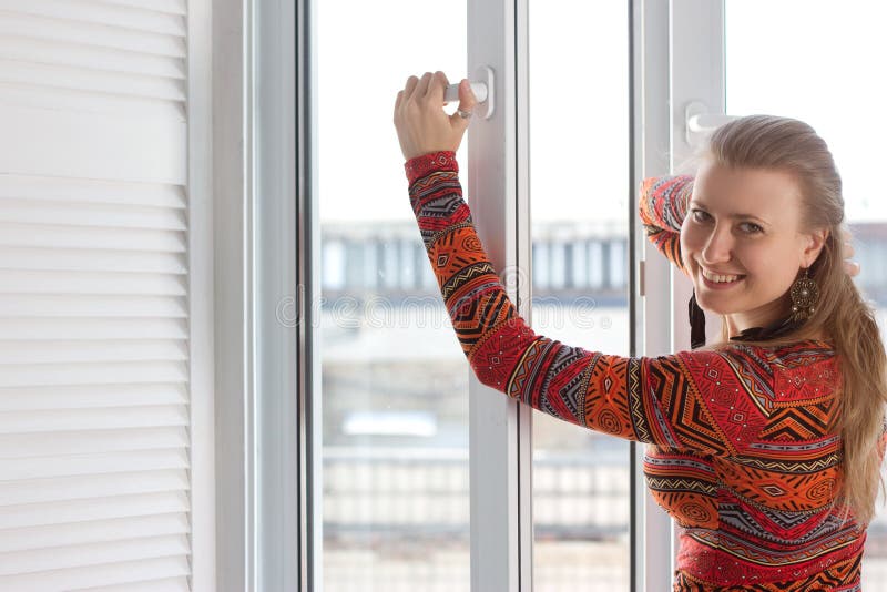 Woman opens a plastic window