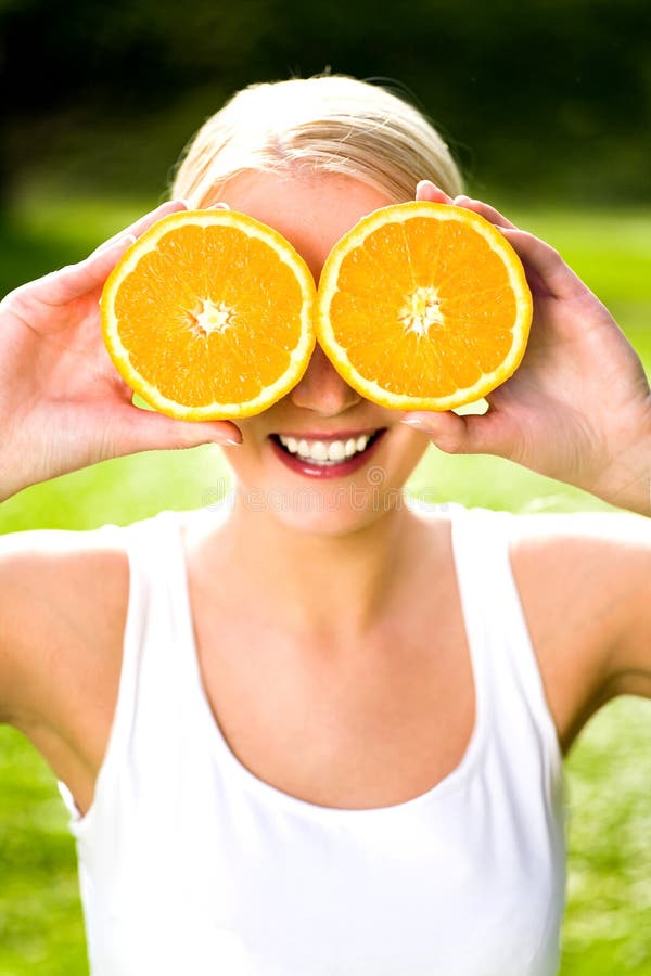 Woman with an orange stock photos Woman with an orange stock photos