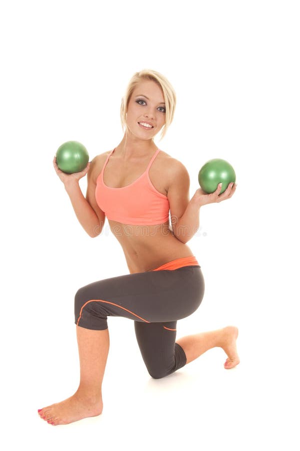 Woman orange sports bra balls kneel