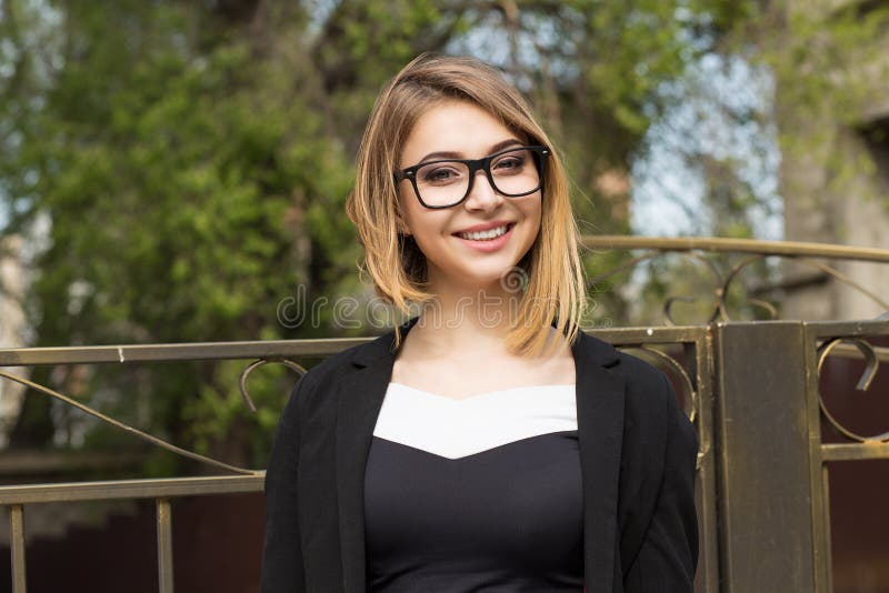 Woman outdoors. Half length body woman girl looking at you camera smile on face, black suit formal wear, eye glasses outside city