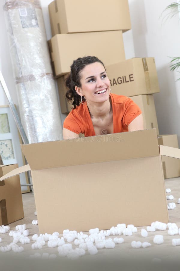 Woman with packing boxes stock photos