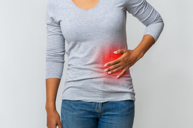 Woman in pain holding her stomach on the left side royalty free stock images Woman in pain holding her stomach on the left side royalty free stock images