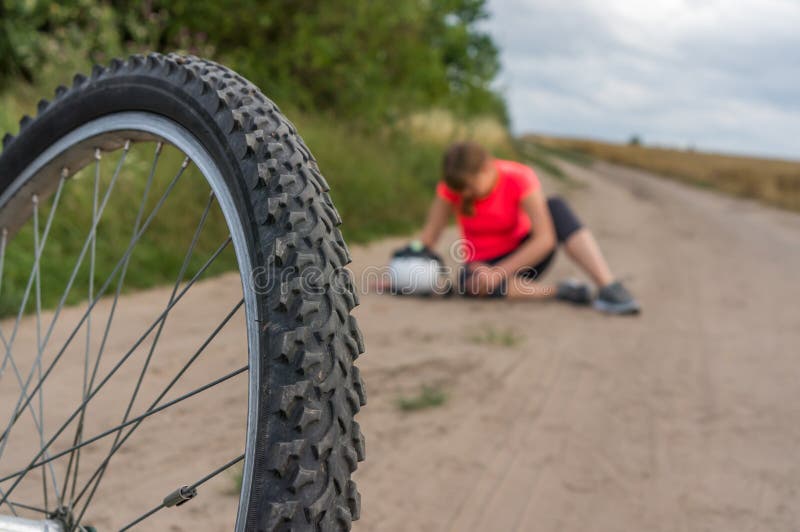 Woman with Pain in Knee after Falling Down from Bicycle Stock Photo