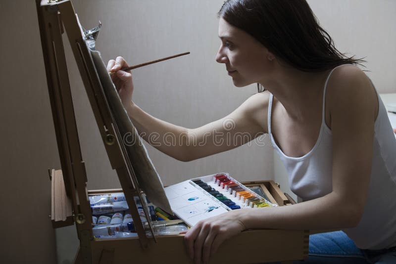 Woman Painting On Easel