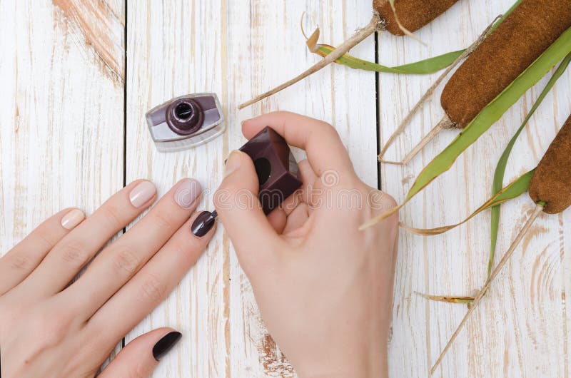 Woman painting her nails.