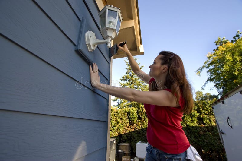 Woman Painting a House - Horizontal