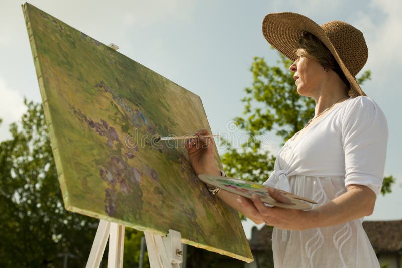 Woman painting outdoors