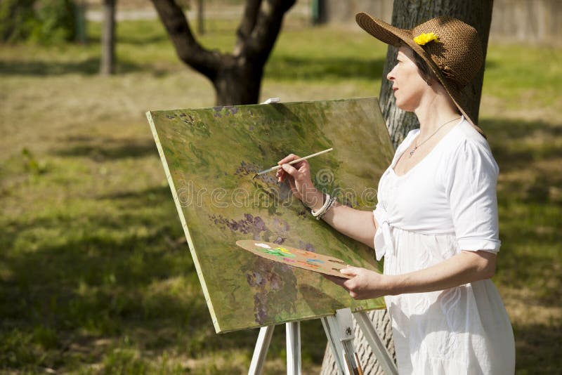 Woman painting outdoors