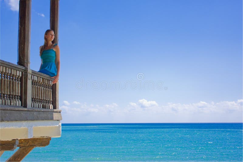 Woman in paradise on a balcony