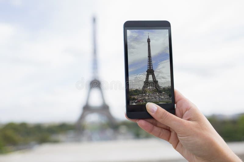 Woman in Paris taking pictures in front of Eiffel Tower, Cell ph stock photography Woman in Paris taking pictures in front of Eiffel Tower, Cell ph stock photography