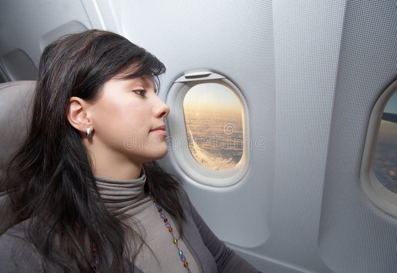 Woman is on passenger seat at airplane