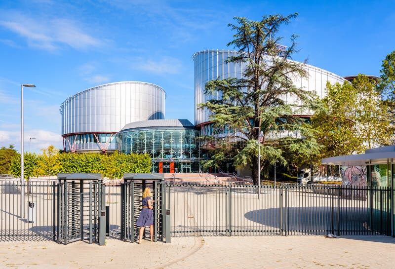 A woman is passing the security turnstile of the European Court of Human Rights building in Strasbourg, France