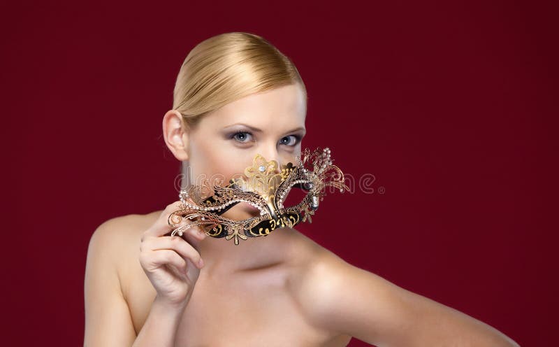 Woman with patterned masquerade mask, isolated on purple