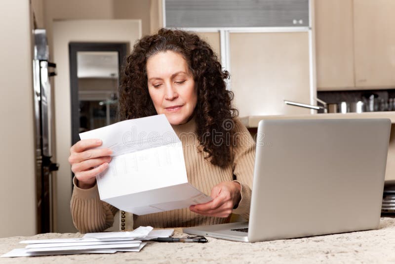 Woman paying bills royalty free stock photography