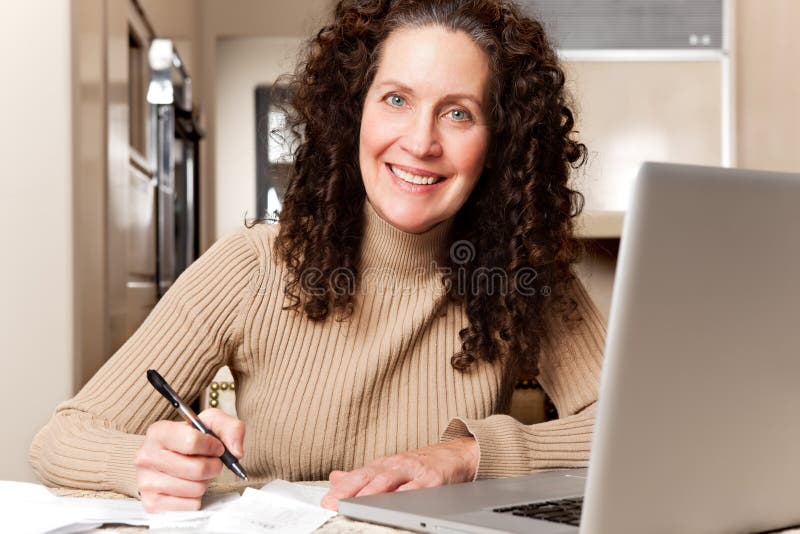 Woman paying bills stock photography