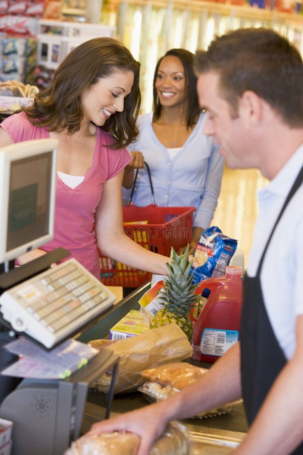 Woman paying for groceries stock photo