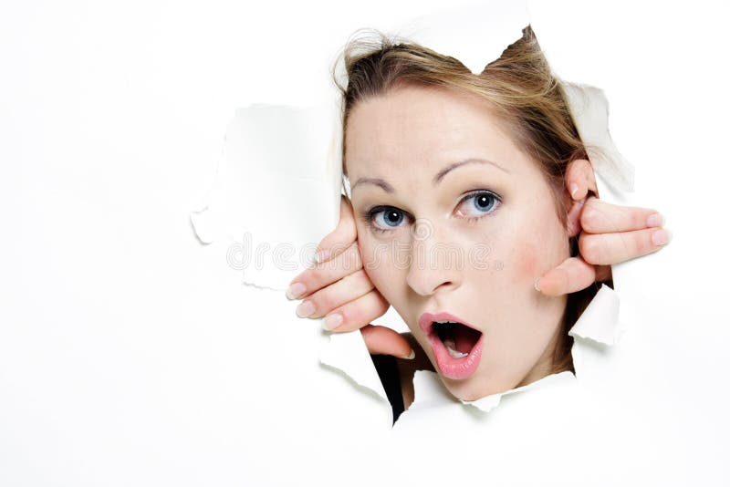 Woman peeping through hole in paper