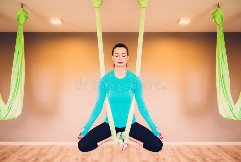 Woman performing antigravity yoga stock photo