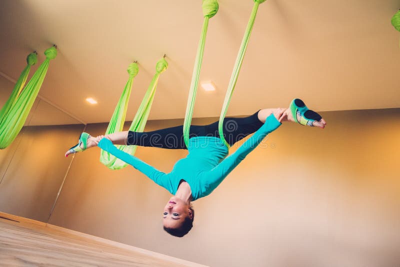 Woman performing antigravity yoga royalty free stock photo