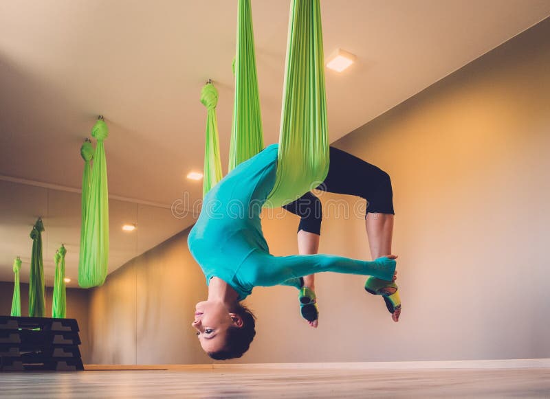 Woman performing antigravity yoga royalty free stock photo