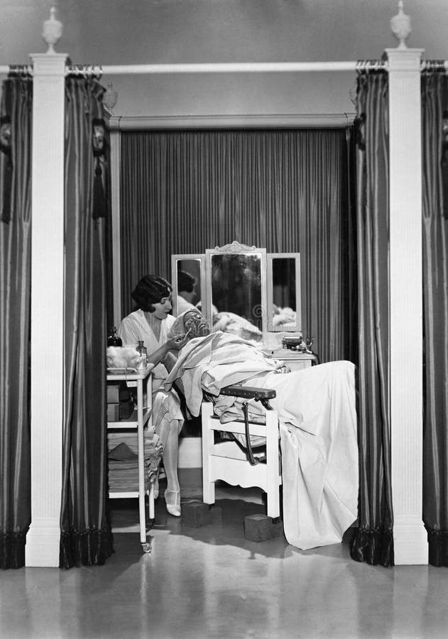 Woman performing facial stock image