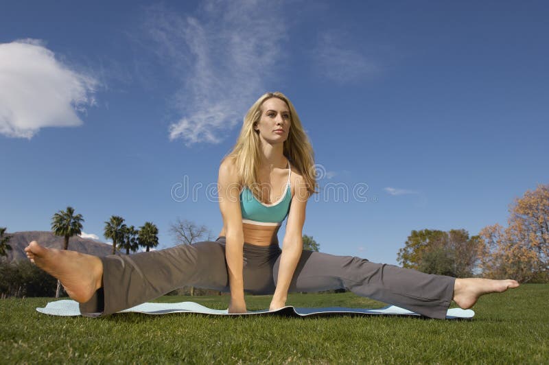 Woman Performing Yoga On Mat stock photography
