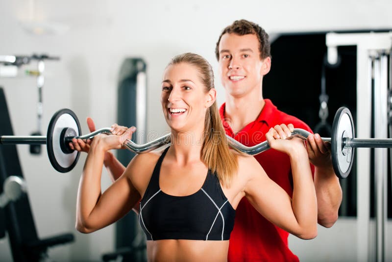 Woman with Personal Trainer in gym royalty free stock photos Woman with Personal Trainer in gym royalty free stock photos