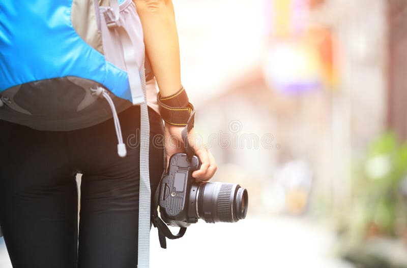 Woman photographer walking on ancient town in guilin, guangxi provice, china