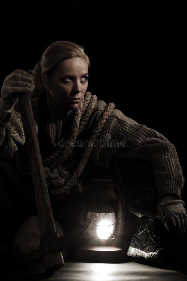 Woman with pick and oil lamp stock photo