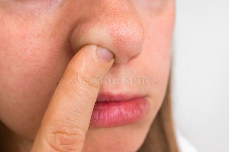 Woman is picking her nose with finger inside