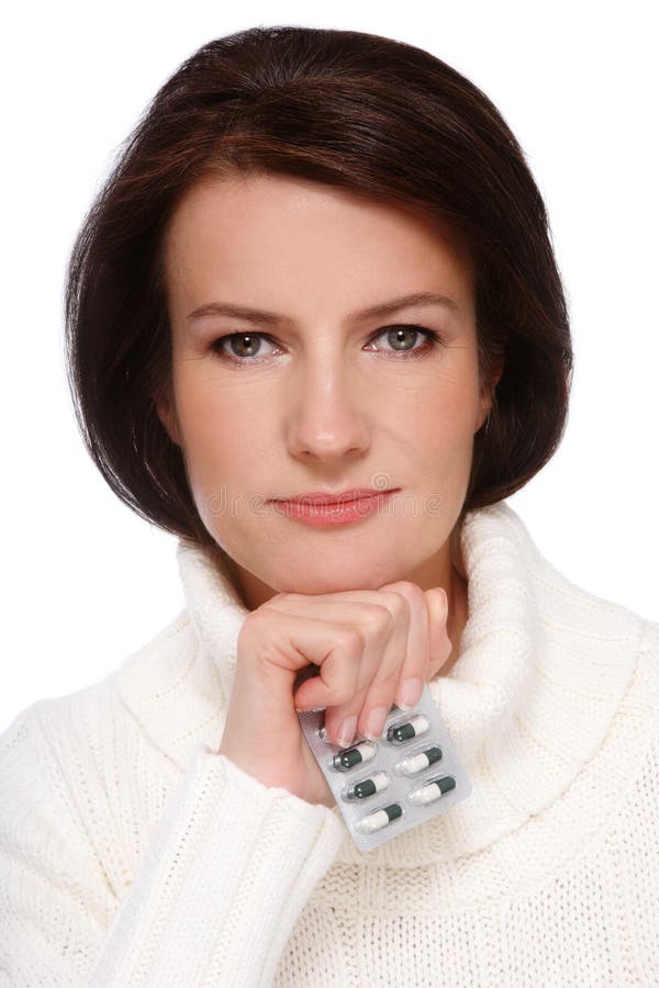 Portrait of attractive healthy middle-aged woman in knitted pullover with pack of pills in hand, over white background. Portrait of attractive healthy middle-aged woman in knitted pullover with pack of pills in hand, over white background