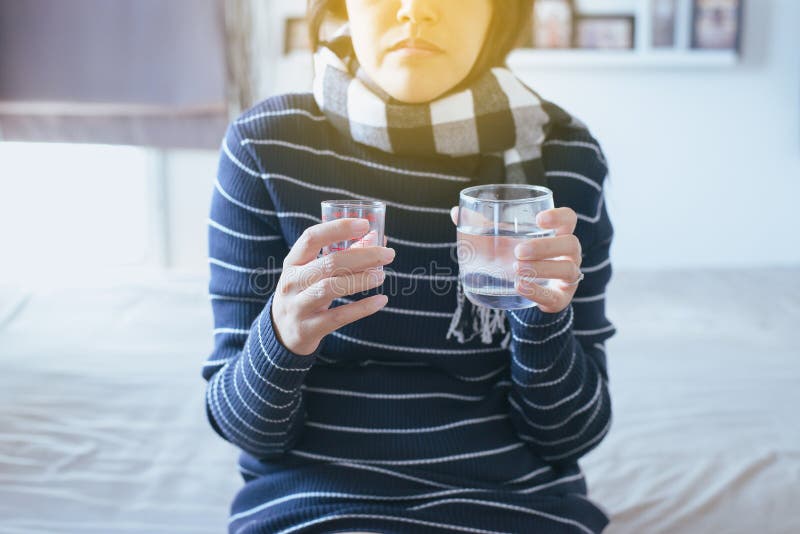Woman with pills or capsules on hand and a glass of water stock photos Woman with pills or capsules on hand and a glass of water stock photos