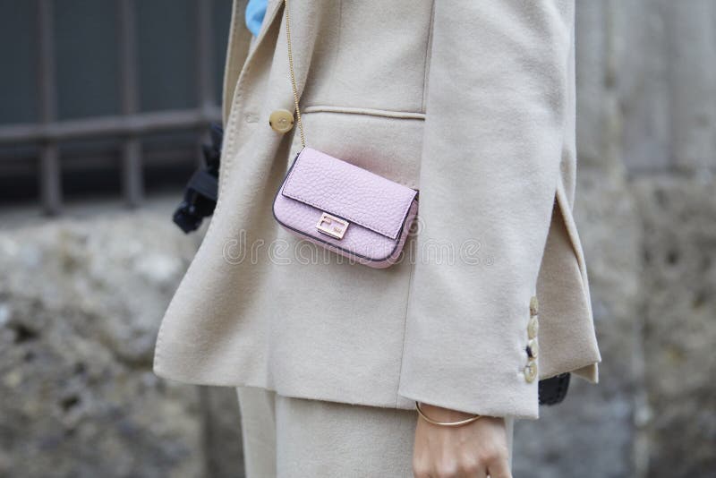 Lisa Hahnbueck wearing beanie, Louis Vuitton bag, blue orange